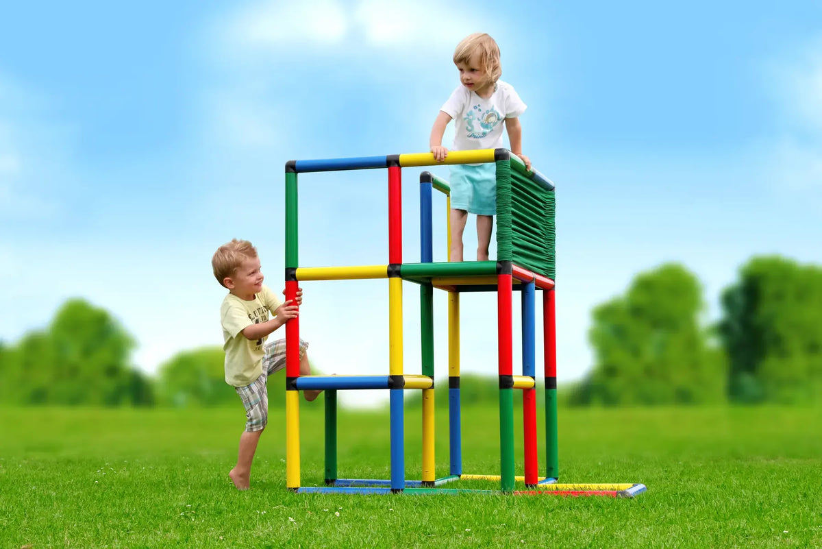 Two children climbing a tall open QUADRO Starter tower outdoors